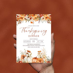 May include: Thanksgiving dinner invitation with a white background and floral border. The text reads "Please join us for Thanksgiving Dinner, November 11, Saturday at 7 PM, The Smith's Residence, 1256 Summer Avenue, Houston, Texas, RSVP: Don 123.456.7890". The bottom of the invitation features a watercolor illustration of pumpkins and fall flowers.