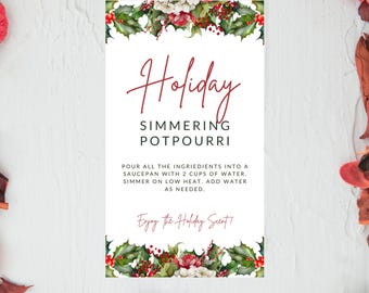 May include: A white card with a red border and green holly leaves. The card has the text "Holiday Simmering Potpourri" and instructions for making a simmering potpourri. The text "Enjoy the Holiday Scent!" is at the bottom of the card.