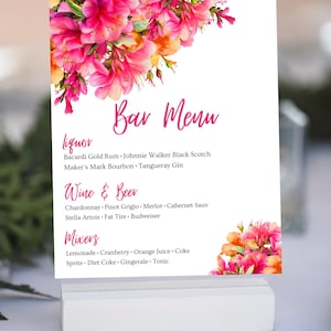 May include: A pink floral bar menu sign with the text "Bar Menu" in pink. The menu lists liquor, wine and beer, and mixers. The liquor options include Bacardi Gold Rum, Johnnie Walker Black Scotch, Maker's Mark Bourbon, and Tangueray Gin. The wine and beer options include Chardonnay, Pinot Grigio, Merlot, Cabernet Sauvignon, Stella Artois, Fat Tire, and Budweiser. The mixers include Lemonade, Cranberry, Orange Juice, Coke, Sprite, Diet Coke, Gingerale, and Tonic.