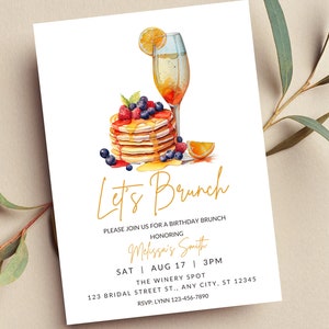 May include: A watercolour illustration of a stack of pancakes with berries and syrup, a glass of mimosa, and the text "Let's Brunch". The invitation is for a birthday brunch honouring Melissa's Smith on Saturday, 17th August at 3 PM at The Winery Spot, 123 Bridal Street, Any City, ST 12345. RSVP to Lynn at 123-456-7890.