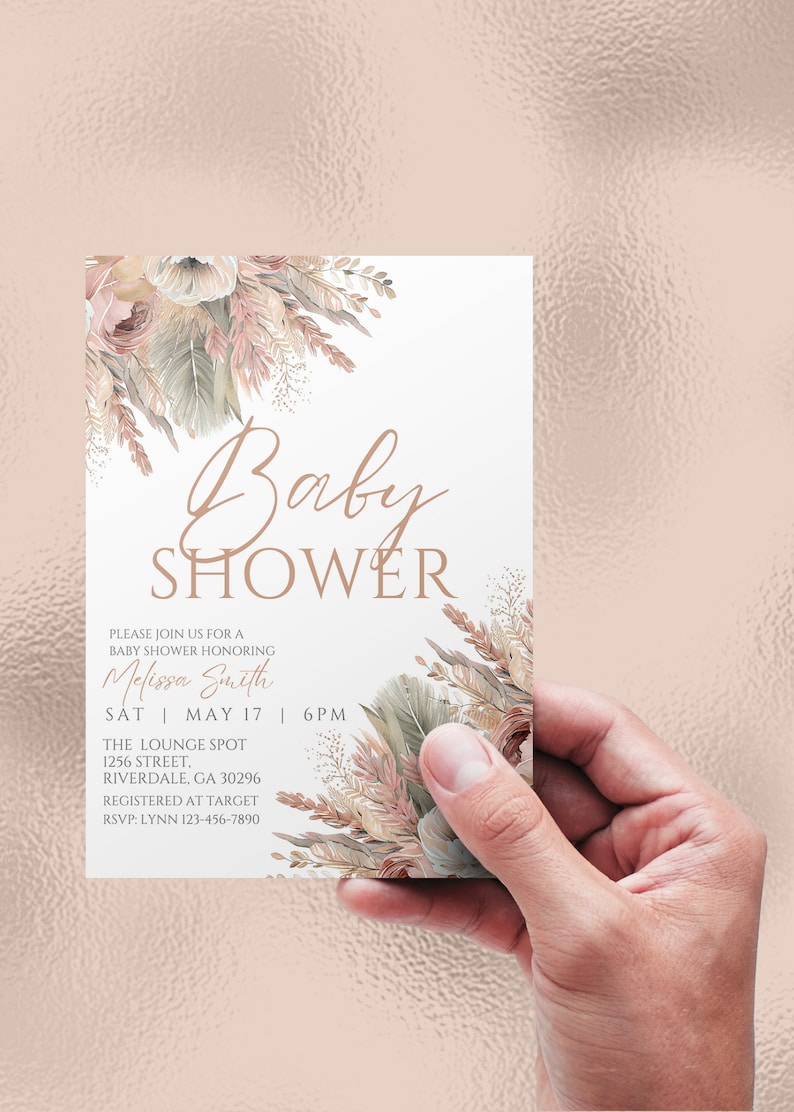 May include: A baby shower invitation with a floral design in shades of beige, brown, and pink. The text reads "Baby Shower" in a cursive font. The invitation includes the name "Melissa Smith", the date "Sat May 17", the time "6PM", the location "The Lounge Spot", the address "1256 Street, Riverdale, GA 30296", and the RSVP information "RSVP: Lynn 123-456-7890".