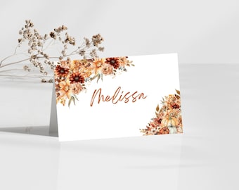 May include: White place card with a floral design in shades of orange, brown, and white. The name "Melissa" is written in a copper-coloured font.