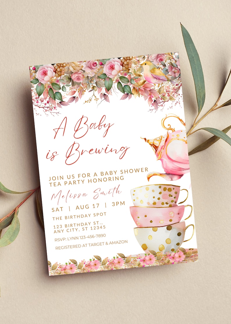 May include: A pink and gold teacup baby shower invitation with a teapot and floral design. The invitation reads "A Baby is Brewing" and includes the date, time, and location of the event. RSVP information and registry details are also included.