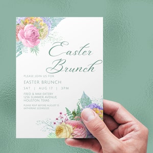 May include: An Easter Brunch invitation with floral accents. The card features the words "Easter Brunch" in elegant script, along with event details. The design includes pink, yellow, and purple flowers. The invitation is held against a light green background.