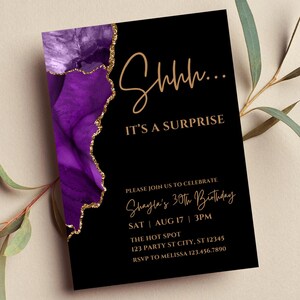 K&ouml;nnte beinhalten: Schwarze Einladungskarte mit lila und goldenem Design. Der Text lautet "Shhh... IT'S A SURPRISE" und Details f&uuml;r Shaylas 30. Geburtstag am 17. August um 15:00 Uhr.