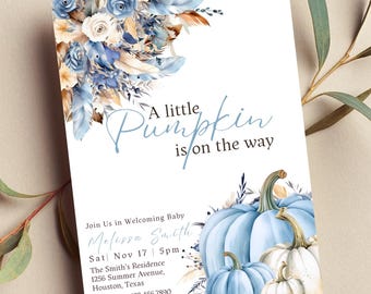 May include: A baby shower invitation with a blue and white pumpkin theme. The invitation features a watercolor illustration of pumpkins, feathers, and flowers. The text reads "A little pumpkin is on the way".