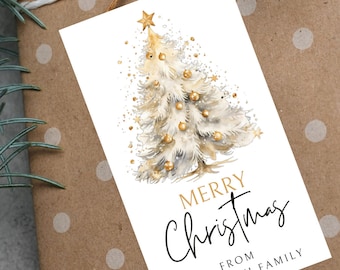 May include: White Christmas gift tag with a gold watercolor illustration of a Christmas tree with gold ornaments and a gold star on top. The text "Merry Christmas" is written in black cursive script with "From The Smith Family" written in black below.