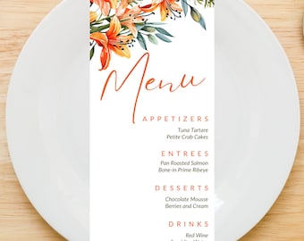 May include: A menu with a floral design featuring orange lilies. The menu lists appetizers, entrees, desserts, and drinks. The appetizers are tuna tartare and petite crab cakes. The entrees are pan roasted salmon and bone-in prime ribeye. The desserts are chocolate mousse and berries and cream. The drinks are red wine and sparkling water.