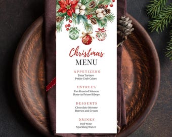 May include: A Christmas menu card with a festive design, featuring red poinsettias, ornaments, and pine branches. The menu includes appetizers, entrees, desserts, and drinks. The card is placed on a brown plate with a dark brown napkin and a fork and knife.