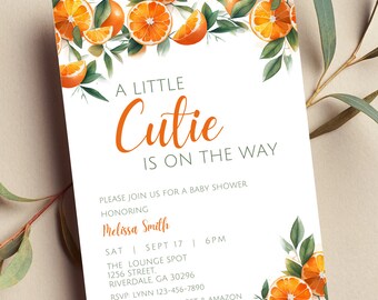 May include: A white baby shower invitation with orange slices and green leaves. The text reads "A Little Cutie is on the Way". The invitation includes the date, time, location, and RSVP information.