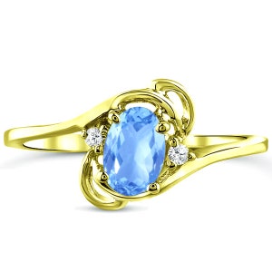 Diamond and Blue Topaz gemstone ring for young ladies in 14K yellow gold.