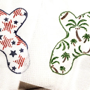 May include: Two embroidered patches. One features a red, white, and blue star and stripe pattern. The other has a green and brown palm tree design. Both are outlined in a contrasting color.