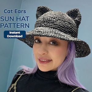 May include: A black sun hat with cat ears. The hat has a wide brim and is made of a woven material. The text "Cat Ears SUN HAT PATTERN" is displayed on the image, along with "Instant Download".