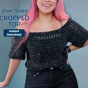 A person with pink hair wears an off-the-shoulder dark speckled crochet top and black jeans, with overlaid text reading Over Sized Cropped Top and Instant Download.
