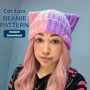 May include: A pink and purple cat ears beanie pattern. The beanie is two-toned, with pink and purple squares. The text "Cat Ears BEANIE PATTERN" and "Instant Download" are displayed on the left side of the image.