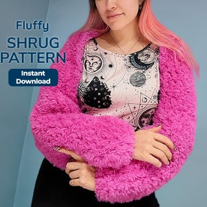 May include: A bright pink fluffy shrug worn over a white top featuring a black celestial print of suns, moons, and stars. Text on the image reads: Fluffy SHRUG PATTERN Instant Download. The shrug has long sleeves and a textured, faux-fur appearance.