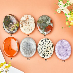 May include: Assortment of eight smooth, polished oval-shaped stones in various colors and patterns, including green, red, white, gray, black, and purple. The stones are arranged in two rows of four, with numbers 15 through 21 printed below each stone.