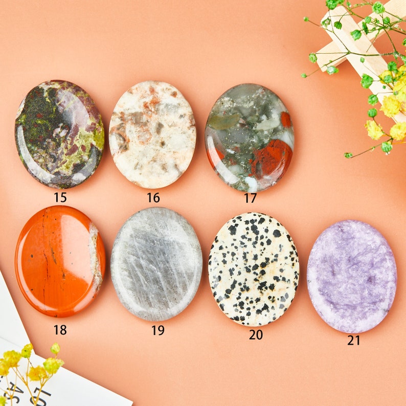 May include: Assortment of eight smooth, polished oval-shaped stones in various colors and patterns, including green, red, white, gray, black, and purple. The stones are arranged in two rows of four, with numbers 15 through 21 printed below each stone.