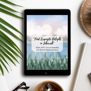 May include: A black tablet displaying a digital graphic with a light blue sky, white clouds, and green grass. The text reads: "Find Exquisite Delight in Jehovah" and "2026-2027 Circuit Assembly with Branch Representative" in a white rectangular box.