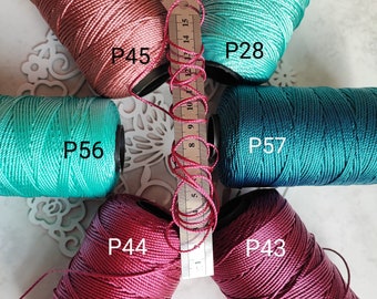 May include: Six spools of thread in various colours, including teal, burgundy, and pink. The spools are labelled with the numbers P28, P43, P44, P45, P56, and P57.