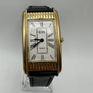 vintage Bill Blass ladies gold tone quartz tank watch white Roman face black faux leather strap curved gift her women mom sale rectangle