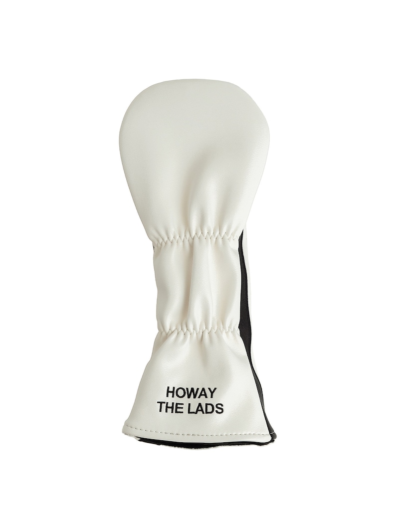 May include: White golf club head cover with black accents and the text "HOWAY THE LADS" in black. The cover is made of a soft material and has a gathered design. The cover is designed to protect golf clubs.