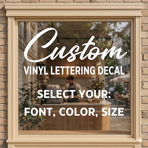 May include: A window decal with the word "Custom" in a script font. Below, the text reads "VINYL LETTERING DECAL" and "SELECT YOUR: FONT, COLOR, SIZE" in white. The background shows a cafe scene.