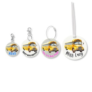 May include: Four round white keychains with a yellow school bus image and text. The keychains feature the text "Brad", "Best Bus Driver", "Mrs. K's Bus Keys", and "Miss Lacy".