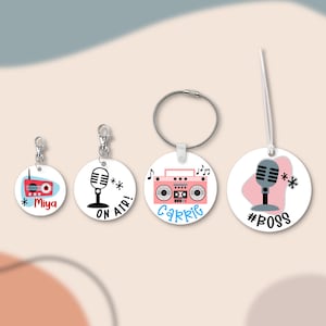 May include: A collection of white, round tags with various designs. One tag features a red radio with the name "Miya". Another says "ON AIR!" with a microphone. A third tag has a pink boombox and the name "Carrie". The last tag has a microphone and the hashtag "#BOSS".