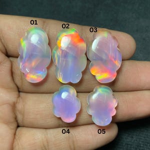 May include: Five opals, each shaped like a flower, showcasing a spectrum of colours. The opals are numbered 01 to 05. They have a translucent, milky white base with flashes of rainbow hues.