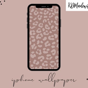 May include: A digital illustration of a smartphone displaying a brown and white leopard print wallpaper. The phone is black with a thin black border around the screen. The background is a light brown color.