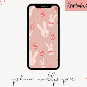 May include: A pink and white iPhone wallpaper featuring a pattern of pink bunnies and red Easter eggs. The background is a light pink colour.
