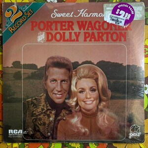 May include: A vintage vinyl record set titled "Sweet Harmony" featuring Porter Wagoner and Dolly Parton. The album cover has a sepia tone with the artists' portraits. The record set is sealed in plastic and includes a "Special Value" sticker.