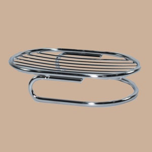 May include: Chrome-plated metal soap dish with a round, wire-mesh base and a curved, ring-shaped holder.