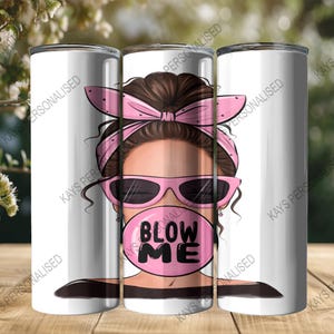A 20oz Skinny Tumbler with an image of a cute messy bun lady head. there is a pink bandana wrapped around her hair and she has pink sunglasses with black lenses on. She is blowing a big pink bubble with the words "BLOW ME" written in black bubble lettering.