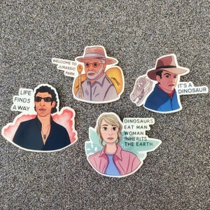 May include: Four illustrated stickers featuring characters from the movie Jurassic Park. The stickers feature the text "Life finds a way", "Welcome to Jurassic Park", "Dinosaurs eat man. Woman inherits the earth." and "It's a dinosaur".