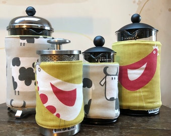 Insulating Cafetiere Cosy. Double sided COW/HEN design.  Machine washable. Velcro tab fastening. French press cover.