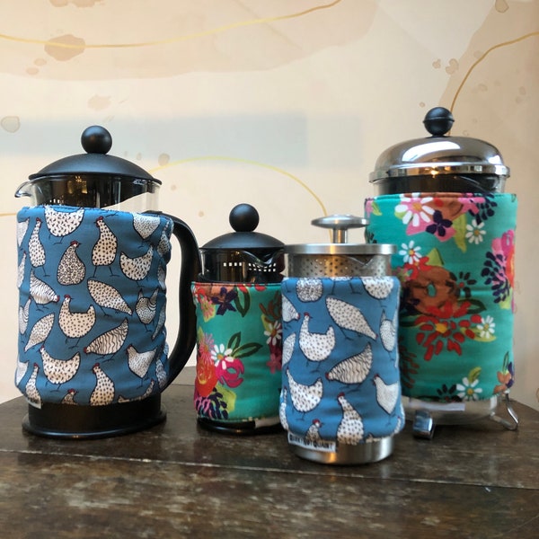 Insulating Cafetiere Cosy. Double sided HENS design.  Machine washable. Velcro tab fastening. French press cover