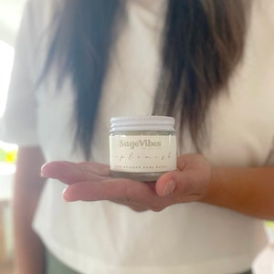 May include: A white jar of hand-whipped body butter labeled "SageVibes" and "Replenish".