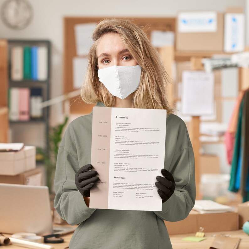 May include: A person wearing a face mask is holding a resume with the heading "Experience". The resume lists work experience from 2008 to 2023.