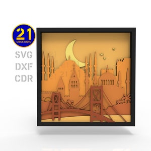 Puede incluir: Un diseño de arte de papel en 3D en capas del horizonte de Estambul, con la Torre de Galata, Santa Sofía y el Puente del Bósforo. El diseño se coloca sobre un fondo de puesta de sol con una luna creciente en el cielo.