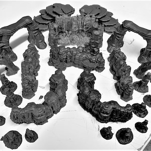 May include: A set of 3D printed black rock formations, including arches, pillars, and walls, for use in tabletop gaming or model building.