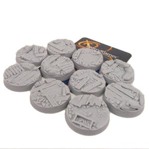 May include: A collection of ten circular grey resin miniature bases featuring a textured surface with sculpted details of wooden planks, debris, and scattered objects. Each base has a flat edge and a detailed top surface for gaming figures.