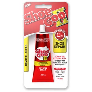 May include: A red and white tube of Shoe Goo II adhesive in its original retail packaging. The product is labelled as crystal clear, 28.4 g, and is designed for shoe repair and protective coating on leather, canvas, suede, fabric, and rubber.