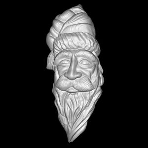 May include: A white ceramic sculpture of a man's face with a beard and a hat. The sculpture is detailed and realistic.