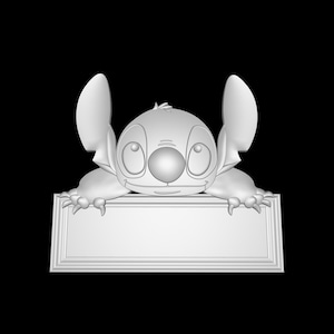 May include: A white 3D printed figurine of Stitch from Lilo & Stitch, peeking over a blank white sign with a raised border.