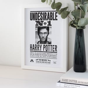 May include: A black and white wanted poster with a photo of Harry Potter. The poster reads "Undesirable No. 1" and "Harry Potter". It also states "Contact the Ministry of Magic immediately if you have any information concerning his whereabouts. Failing to report will result in imprisonment. Reward 10,000 Galleons on his head."