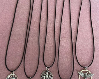 Choice of a Tibetan silver pendant charms on a 16” black thong