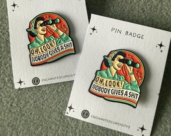 Humour  enamel metal pin “ Oh Look nobody gives a shit ”