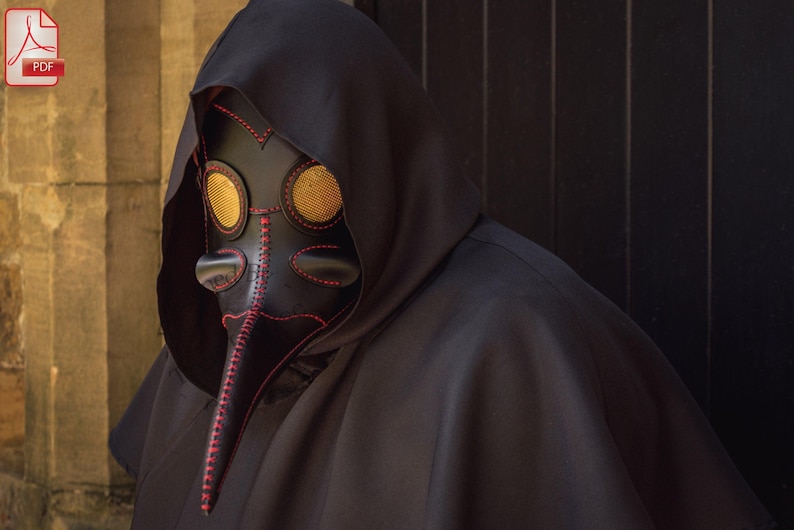 May include: A black leather plague doctor mask with a long beak and two round yellow eye pieces. The mask is decorated with red stitching.